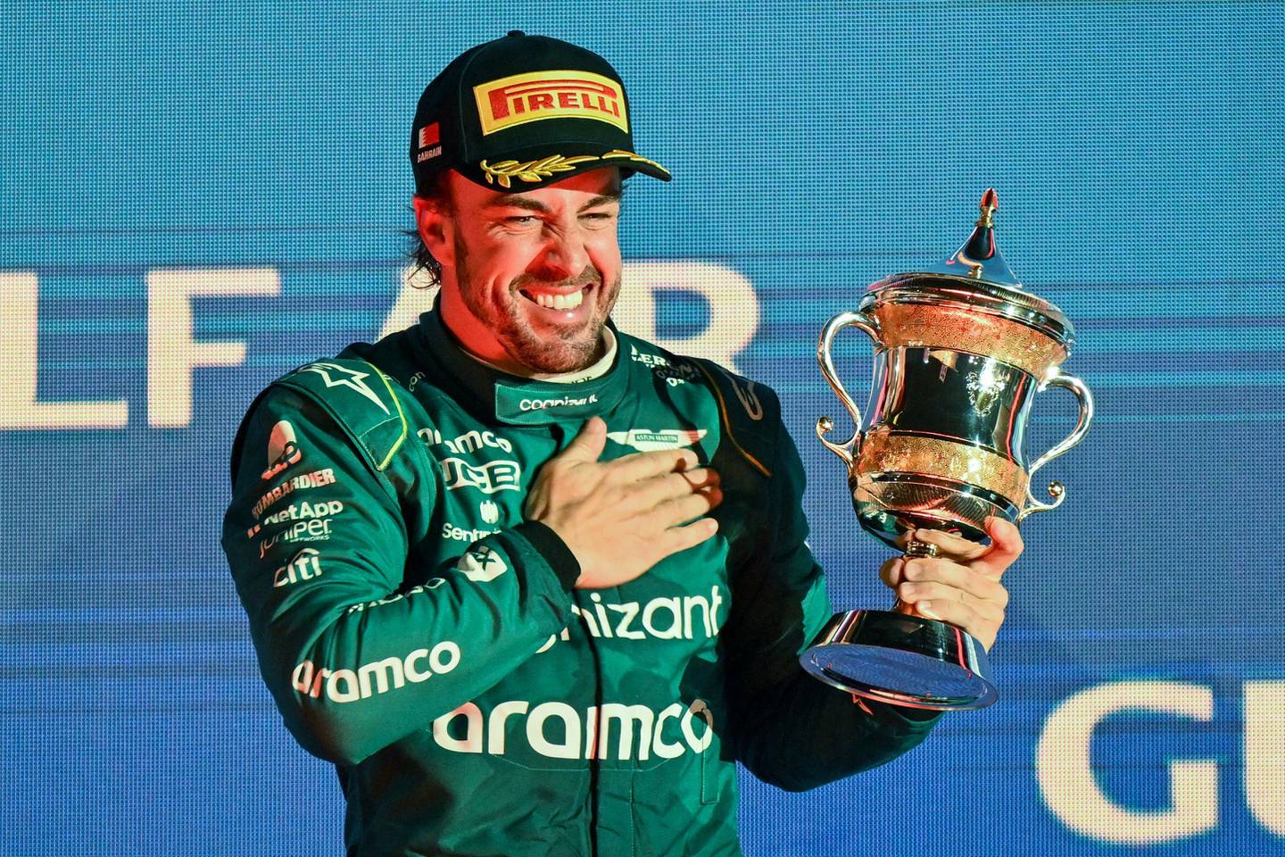 Aston Martin's Fernando Alonso celebrates on the podium with a third place after the Bahrain Formula One Grand Prix on March 5.dfd