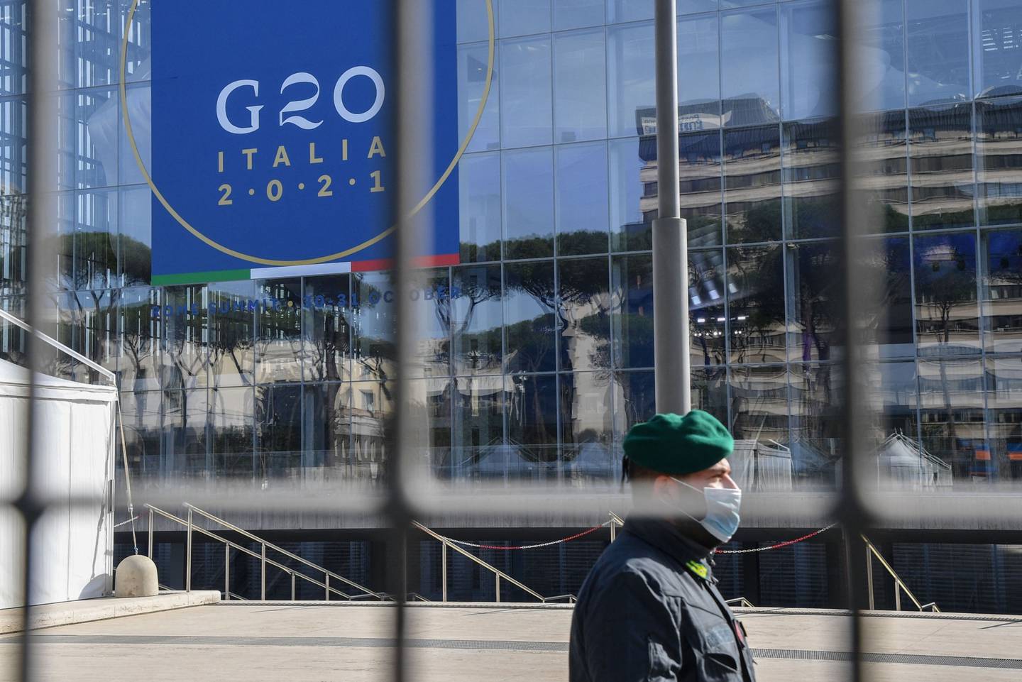 An officer of the Guardia di Finanza (GdF) Italian law enforcement agency stands guard outside the convention center "La Nuvola".