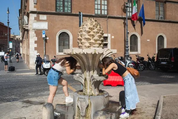 Visitantes toman agua en una fuente en Italia durante una nueva ola de calor