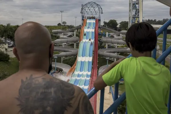 Visitors watch as riders go down a slide at a water park in Itupeva, Sao Paulo state.