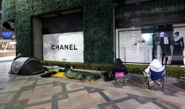 Shoppers wait in line with tents and portable chairs outside a Chanel store in Seoul.
