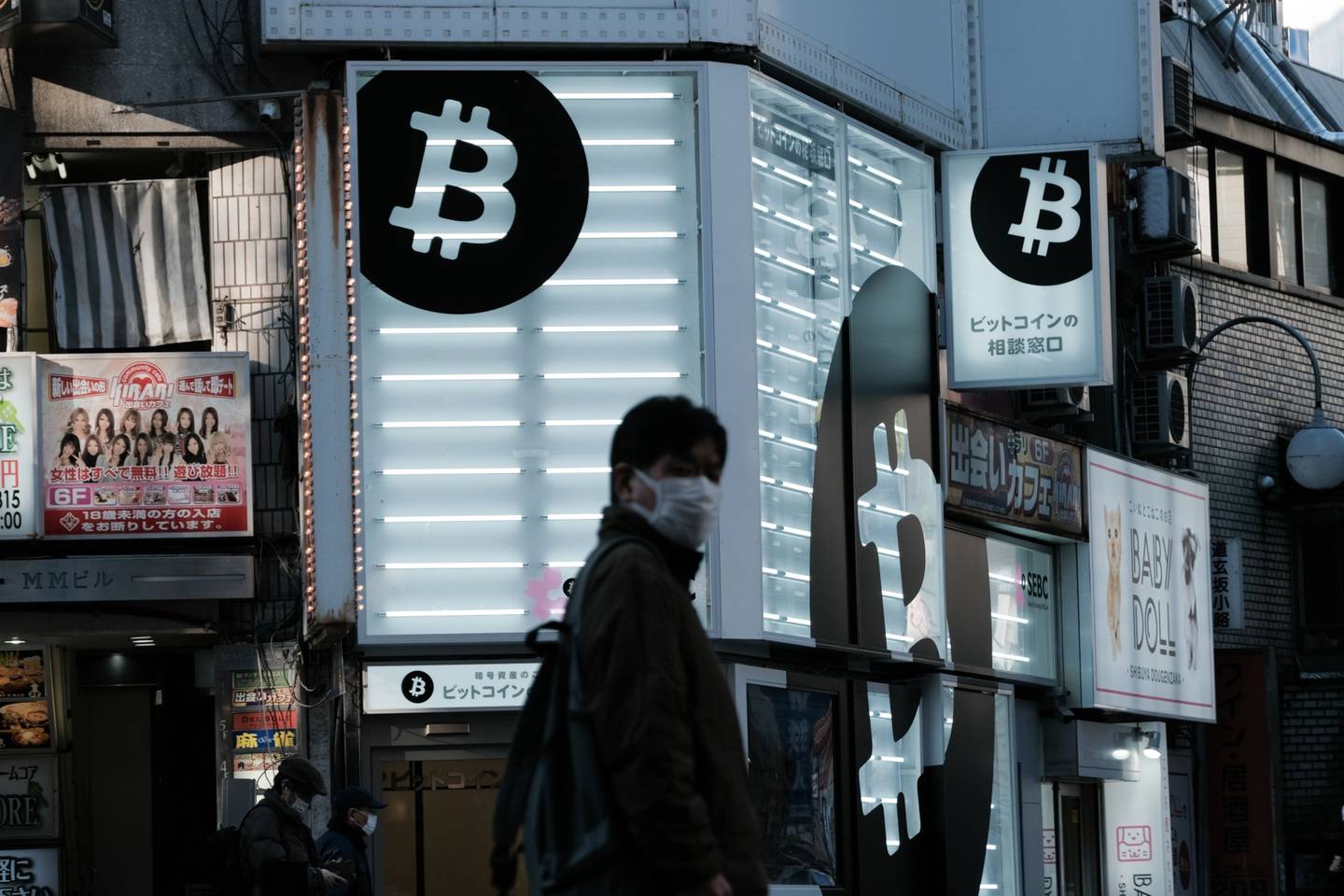 A pedestrian walks past a Sakura Bitcoin Exchange Inc. store in the Shibuya district of Tokyo.
