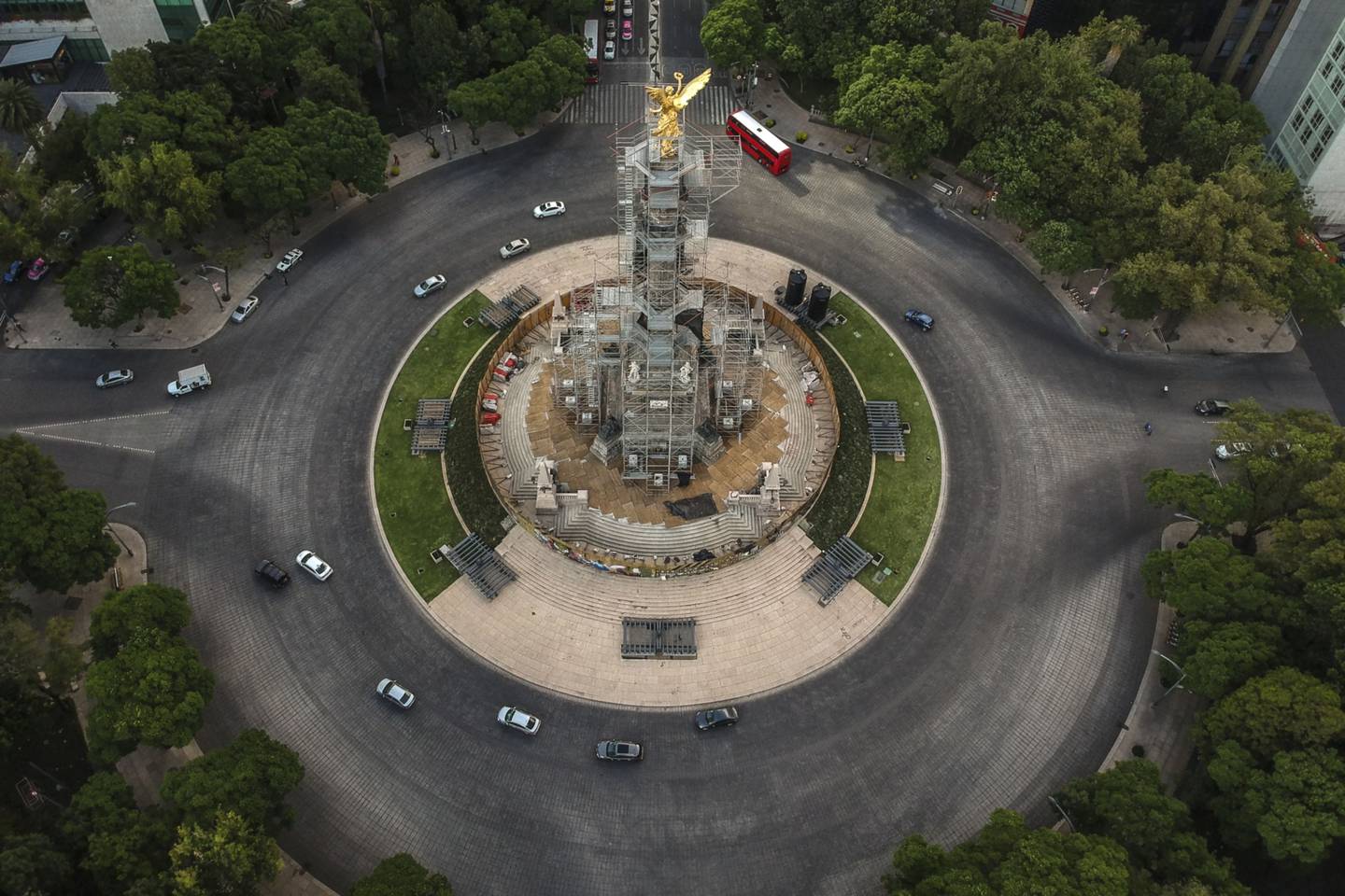 Vehicles travel along a nearly empty Reforma Avenue past the Angel of Independence monument in an aerial photograph taken over Mexico City.