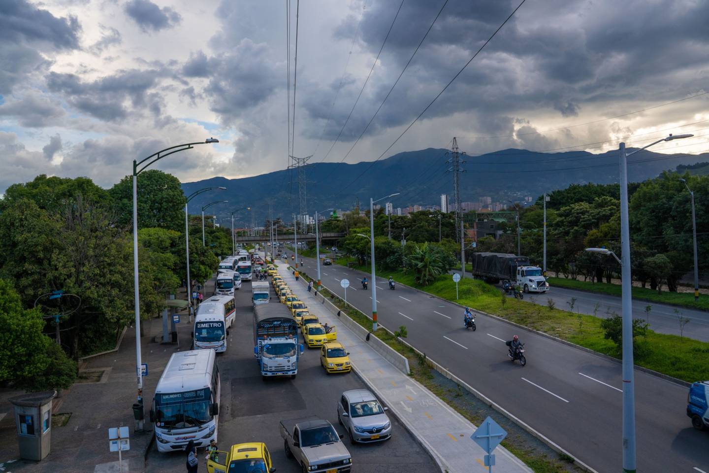 Taxis and buses wait on a highway in Medellin, Colombia, on Thursday, May 20, 2021.