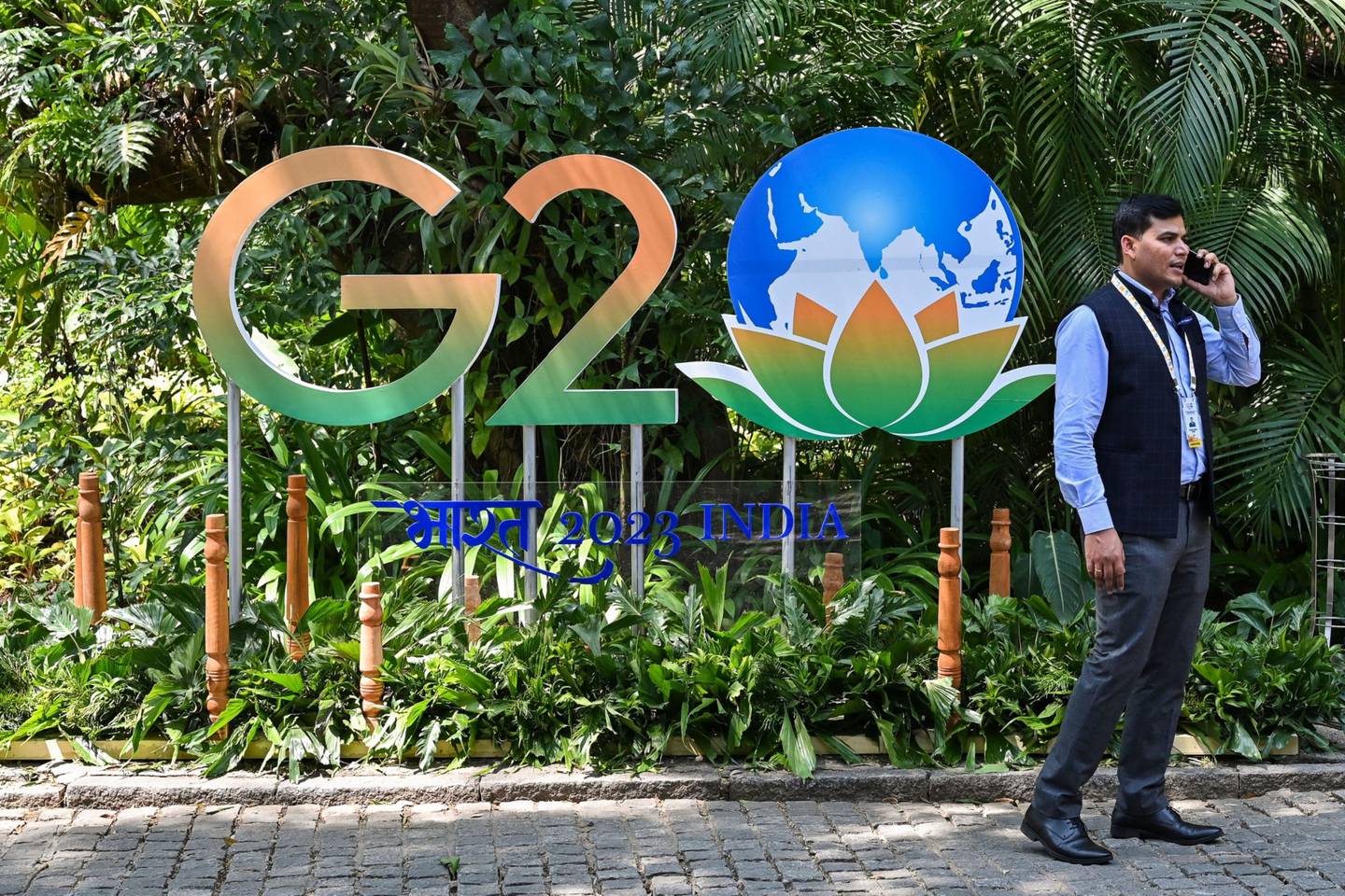 An official walks past India's G20 logo at the venue of the 1st Environment and Climate Sustainability working group meeting under Indias G20 Presidency in Bengaluru on February 9, 2023. Photographer: Manjunath Kiran/AFP/Getty Images