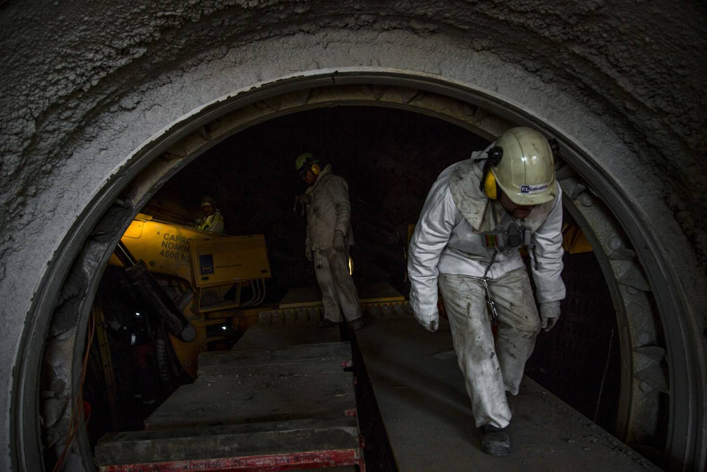 Workers perform a maintenance check inside the Codelco Ministro Hales mine complex near Calama, Chile.
