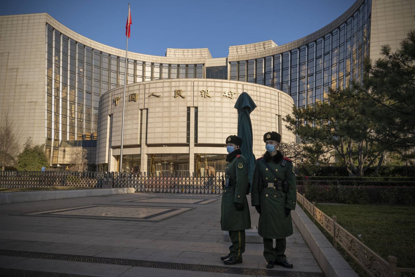 People's Liberation Army soldiers stand in front of the People's Bank of China (PBOC) in Beijing, China, on Monday, Dec. 13, 2021.