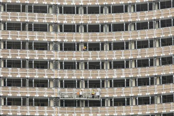 Construction workers operate on a platform at a hotel renovation project in Shanghai, China.