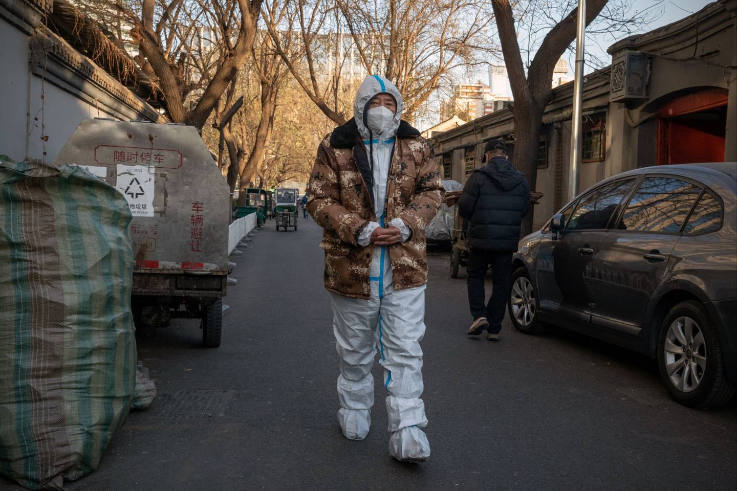 A worker in protective gear in Beijing, China, on Monday, Dec. 5, 2022. China is reporting fewer Covid-19 cases as a wave that started to accelerate last month appears to be tailing off amid a pullback in the sweeping testing regime that saw a negative result needed to even enter a public park. Source: Bloomberg