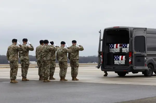 U.S. Army transfer team salutes as the remains of service members killed in Jordan are placed in a vehicle during a dignified transfer at Dover Air Force Base on Feb. 2 in Dover, Delaware. Photographer: Kevin Dietsch/Getty Images