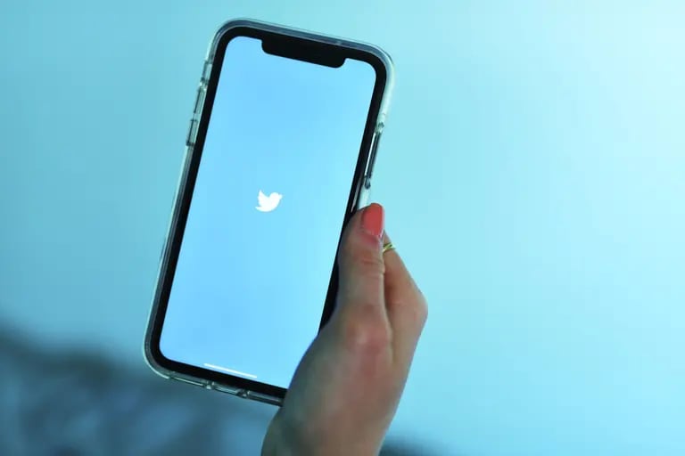 The Twitter Inc. logo is displayed on an Apple Inc. iPhone.dfd