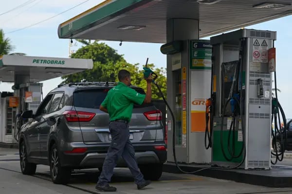 A worker refuels a vehicle at a Petroleo Brasileiro SA (Petrobras) gas station in Rio de Janeiro.