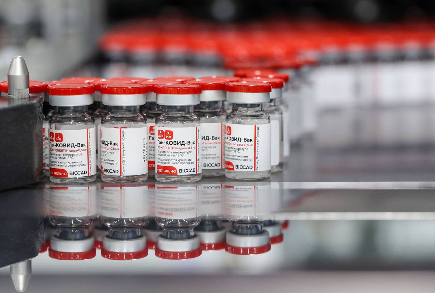 Labelled vials of the Sputnik V Covid-19 vaccine move along the packaging line at the Biocad pharmaceutical factory in Strelna, near St. Petersburg, Russia, on Friday, July 23, 2021. The Argentine government complained to Russia over delays in delivering its Sputnik V vaccine, saying the lack of supplies has left the South American country in a very critical situation, putting the government at risk. Photographer: Andrey Rudakov/Bloomberg