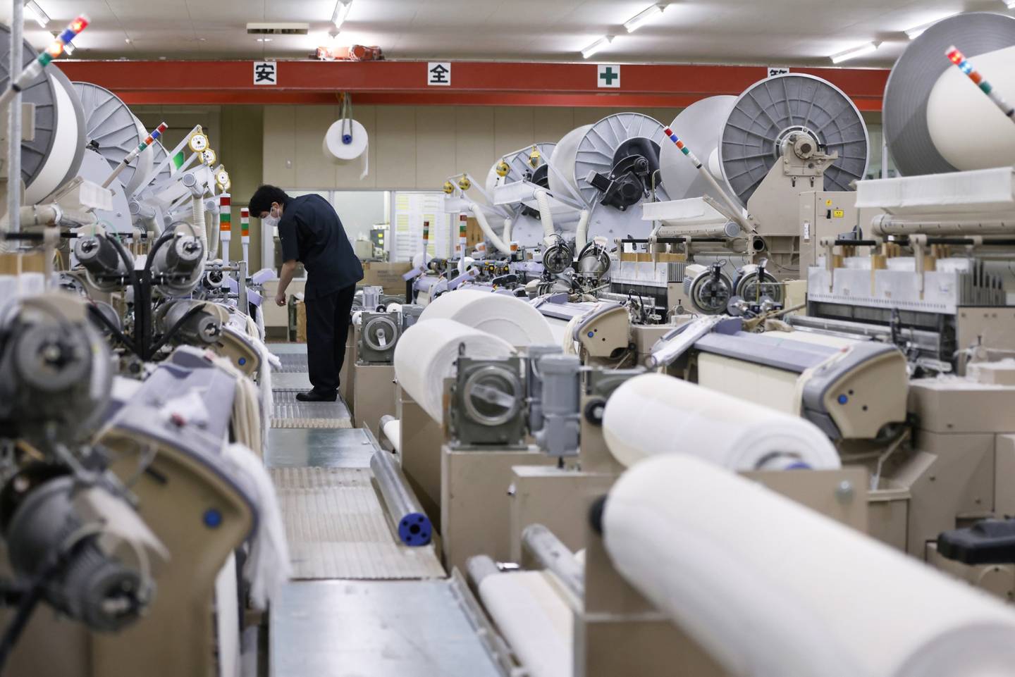 An employee monitors a weaving machine during towel production at Hotman Co.'s factory in Ome, Tokyo Metropolis, Japan, on Tuesday, May 10, 2022. Japan is scheduled to release its first-quarter gross domestic product (GDP) figures on May 17. Photographer: Kiyoshi Ota/Bloomberg