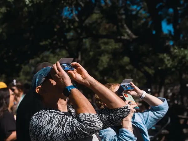 Los espectadores usan gafas de observación solar durante un eclipse solar en Driftwood, Texas, EE. UU., el sábado 14 de octubre de 2023.