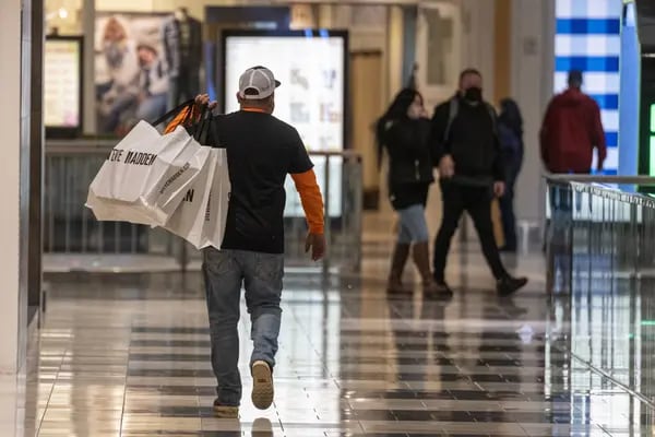 A shopper carrying bags in the Westfield San Francisco Centre mall in San Francisco, California, on Wednesday, December 22, 2021.