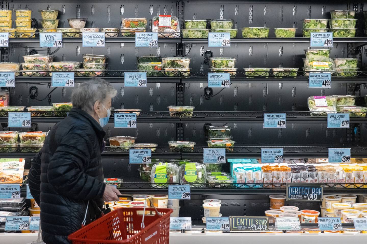 A customer shops in the prepared food section of the Trader Joe's Upper East Side Bridgemarket grocery store in New York, U.S., on Thursday, Dec. 2, 2021. The century-old vaulted market under the Queensboro Bridge has reopened on Thursday as a Trader Joe's.