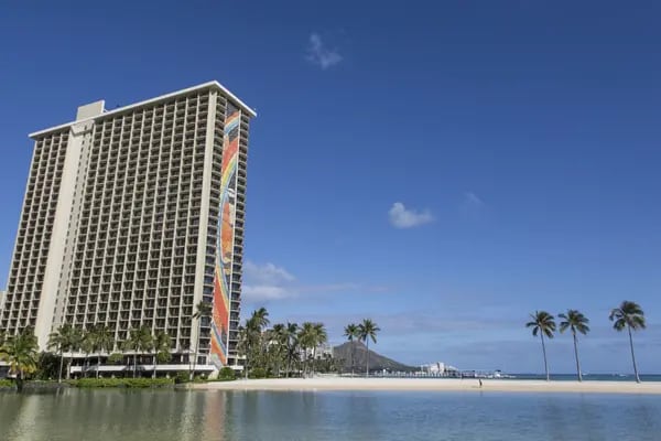 The Hilton Hawaiian Village Wakiki Beach resort stands next to the Duke Kahanamoku Lagoon in Honolulu, Hawaii, U.S., on Monday, May 11, 2020. Hawaii reports no new virus cases for the first time in nearly two months, the Associated Press reported. Photographer: Marie Eriel Hobro/Bloomberg