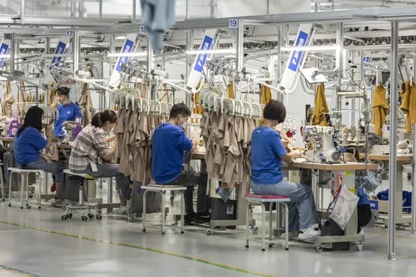 Los empleados usan máquinas de coser en una línea de producción de prendas de vestir en la fábrica inteligente de Alibaba Group Holding Ltd. conocida como Xunxi, que se traduce literalmente como "rinoceronte rápido", en Hangzhou, China, el martes 13 de octubre de 2020. La corporación más grande de China dio a conocer en septiembre su primera fábrica inteligente, un experimento secreto que Alibaba ha estado realizando durante tres años en las afueras de su ciudad natal de Hangzhou. Fotógrafo: Qilai Shen/Bloomberg