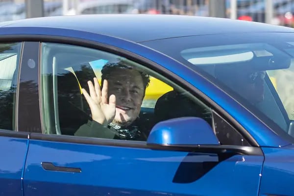 Elon Musk, chief executive officer of Tesla Inc., waves to the media on arrival at the Tesla Inc. Gigafactory.