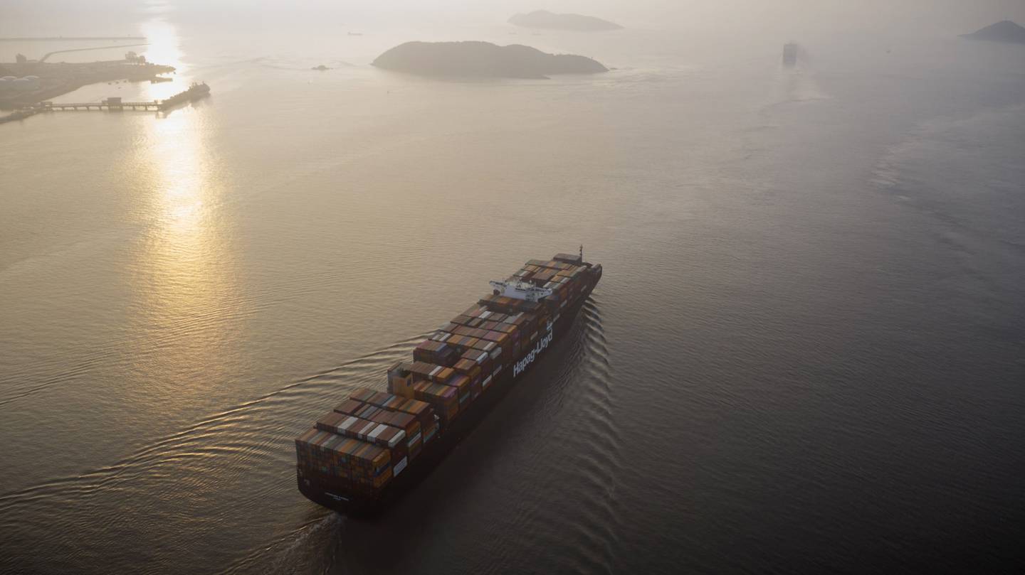 A container ship sails out to sea from Yangshan Deepwater Port in China. Photographer: Qilai Shen/Bloomberg