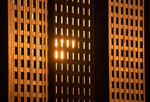 Sunlight is reflected on the windows in a residential apartment block.