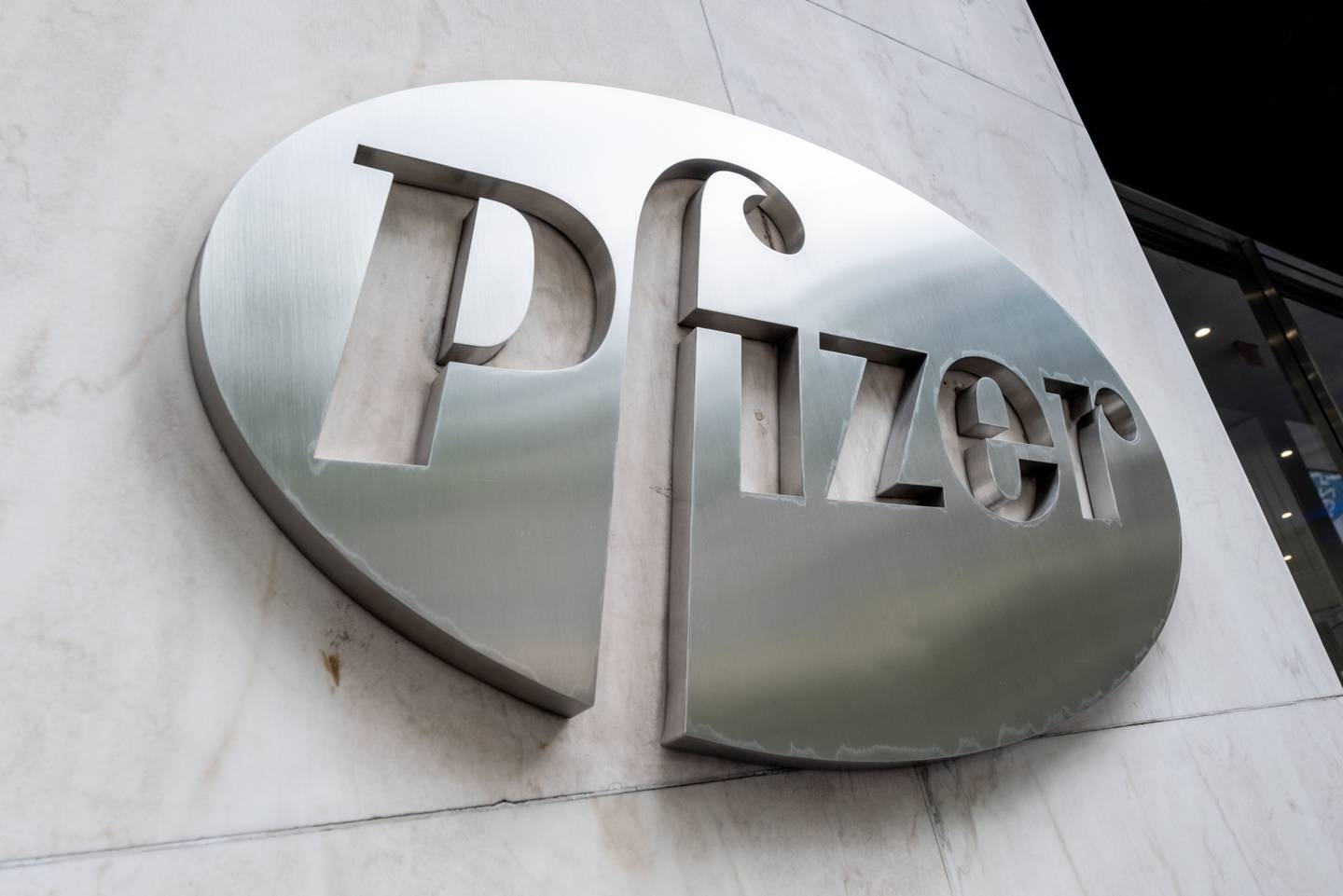 Pfizer Inc. signage is displayed outside the company's headquarters in New York.
