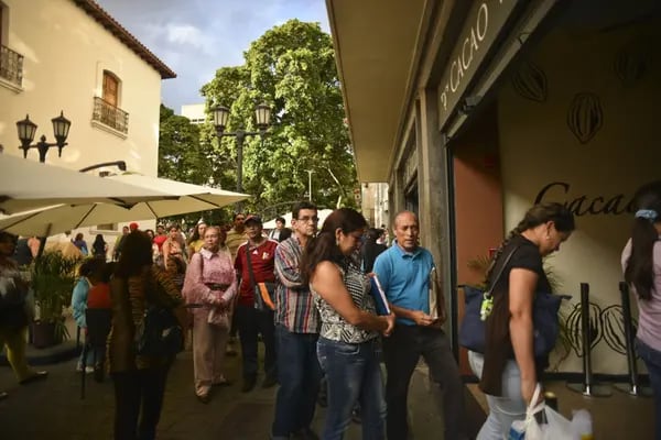 Customers wait in line at Cacao Venezuela, a state-owned chocolate shop that sells government-subsidized chocolate products in downtown Caracas, Venezuela on Monday, Jan. 14, 2013. Photographer: Meridith Kohut/Bloomberg