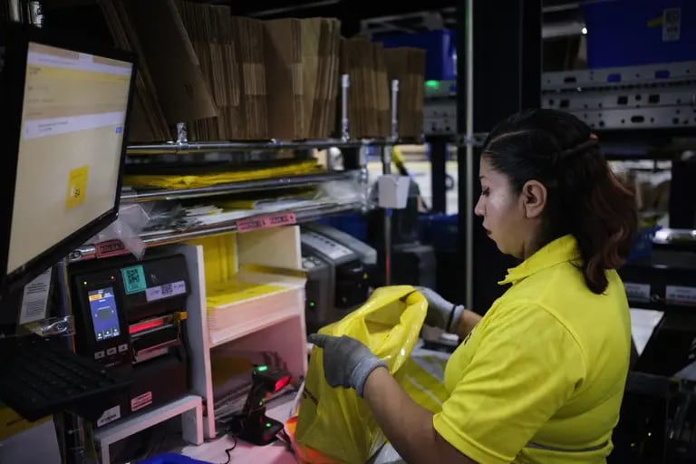 A worker packs an order for shipment at the MercadoLibre Distribution Center (Cedis) at Prologis Park Grande in Tepotzotlan, Mexico state, Mexico, on Tuesday, Nov. 29, 2022.dfd