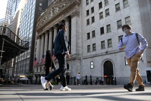 Pedestrians pass in front of the New York Stock Exchange (NYSE) in New York, U.S., on Tuesday, Sept. 7, 2021. Equities retreated from near-record highs as U.S. trading resumed after the Labor Day holiday. Photographer: Michael Nagle/Bloomberg