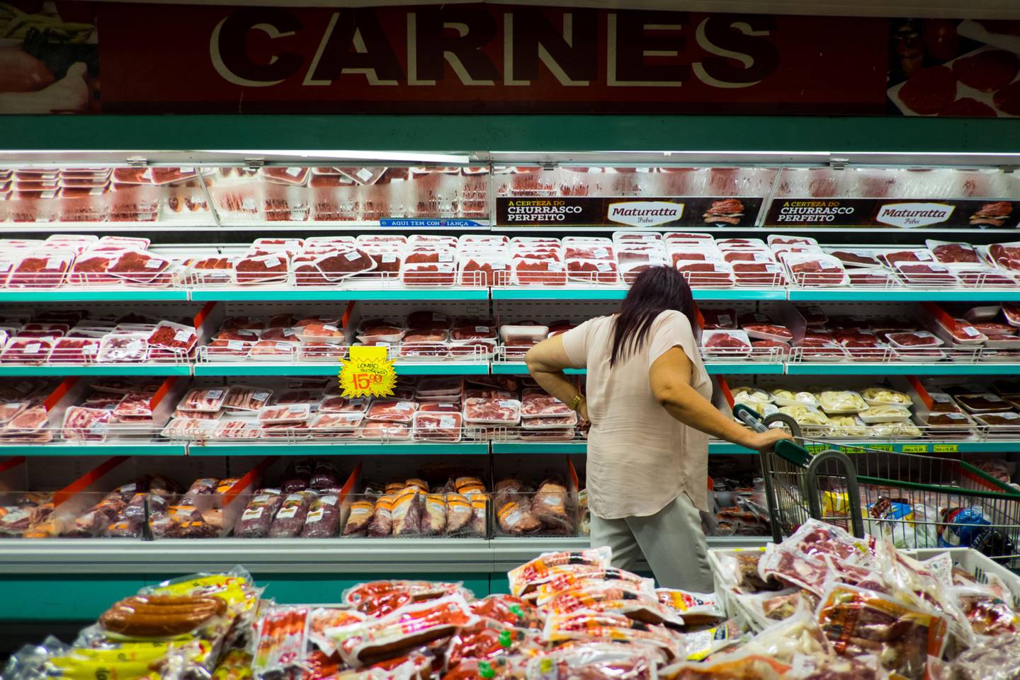 A customer shops for meat in a supermarket in Sao Paulo.