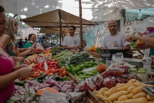 Shoppers browse produce at an outdoor market in the Tijuca neighborhood of Rio de Janeiro.