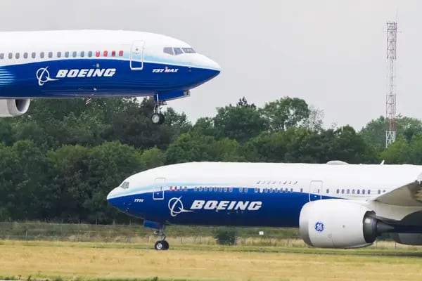 A Boeing 737-10 Max aircraft lands beside a Boeing B777-9 during a flight demonstration at the 2023 Paris Air Show.