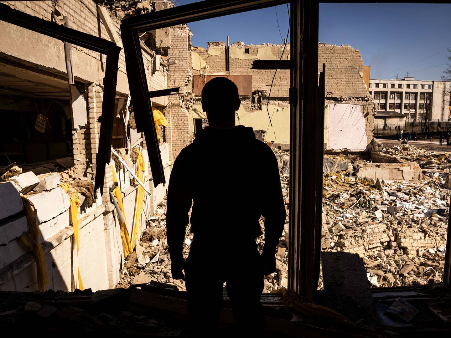 A man stands inside a damaged school in the city of Zhytomyr, northern Ukraine, on March 23, 2022.