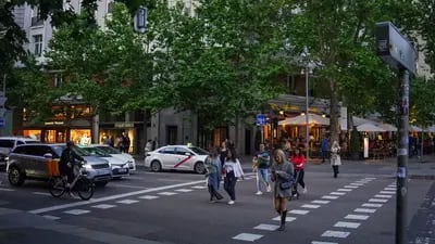 Pedestrians cross a street lined with upmarket stores in the Salamanca district of Madrid, Spain, on Saturday, May 27, 2023. A flood of funds from well-heeled Latin Americans is changing the face of Madrid: driving property prices soaring and creating a sizzling hot high-end dining scene.