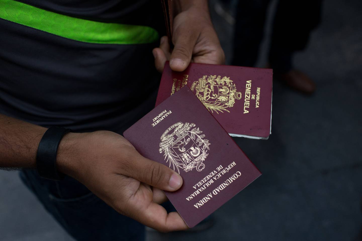 A person holds two expired passports while waiting in line to apply to for a new passport at the Administrative Service of Identification, Migration, and Foreigners (SAIME) in Caracas, Venezuela, on Tuesday, Sept. 18, 2018. For those who can afford to pay bribes to speed things along, the going rate for one passport is more than $2,000, over 68 times the monthly minimum wage. Photographer: Manaure Quintero/Bloomberg