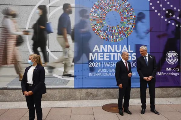 Bruno Le Maire, France's finance minister, right, and Olaf Scholz, Germany's finance minister, stand outside the International Monetary Fund (IMF) headquarters during the annual meetings of the IMF and World Bank Group in Washington, D.C., U.S., Wednesday, Oct. 13, 2021. Photographer: Ting Shen/Bloomberg