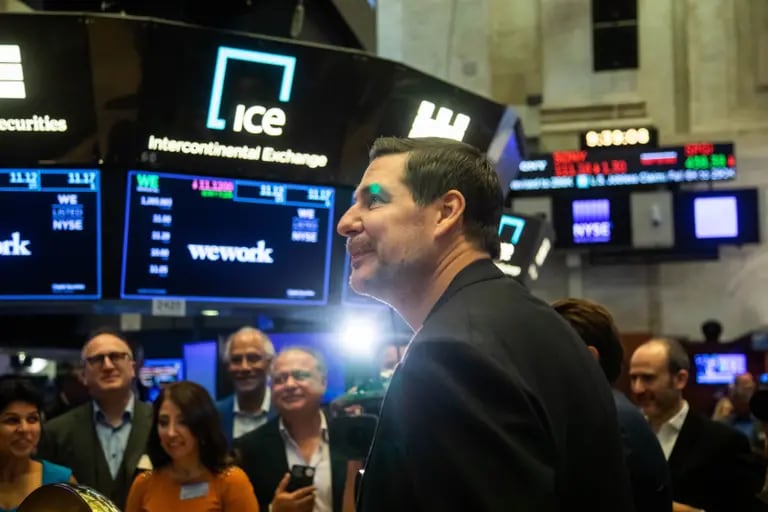 Marcelo Claure looks at a monitor on the floor of the New York Stock Exchange (NYSE) in New York, U.S., on Thursday, Oct. 21, 2021, when WeWork began trading with him as a chairman.dfd