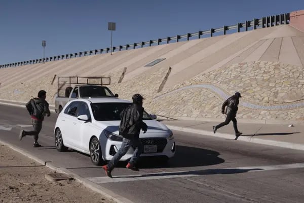 Migrants attempt to evade law enforcement after crossing the US and Mexico border in El Paso, Texas.