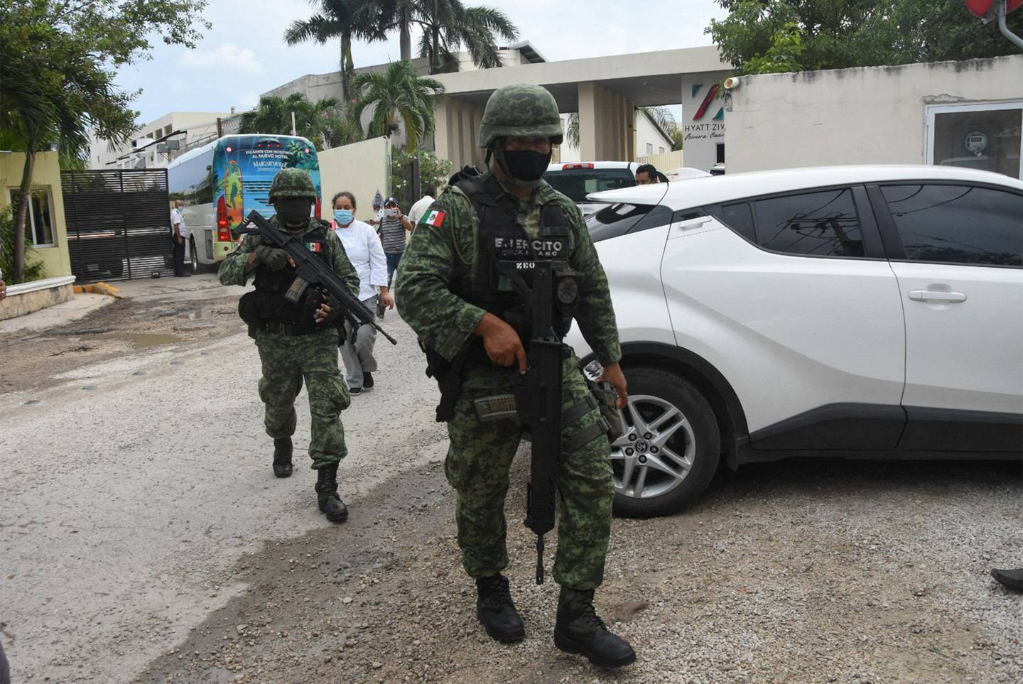 Mexican soldiers walk outside the Hyatt Ziva Riviera hotel in Puerto Morelos, Quintana Roo state, Mexico, on November 4, 2021, after a shooting.