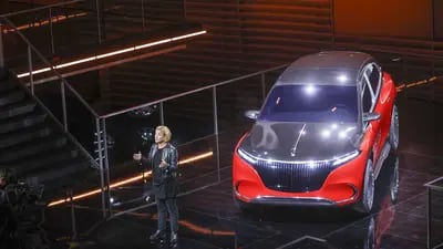 Britta Seeger, a member of Daimler's management board, speaks while unveiling the Mercedes-Maybach EQS. The bulky luxury SUV includes massive amounts of chrome, 24-inch Bowl rims on its wheels and a first-class rear suite with two individual seats, the customary champagne holder and cooling box, and a high-end sound and visual entertainment system. According to Mercedes, a non-Maybach EQS electric SUV will debut in 2022, with the Mercedes-Maybach EQS likely to follow. Photographer: Alex Kraus/Bloomberg