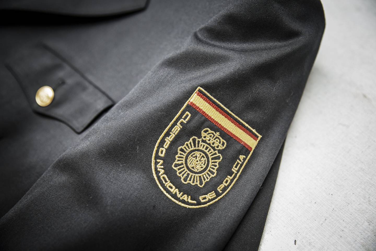 The logo of the Cuerpo Nacional de Policia, the Spanish civilian police force, is displayed on a jacket at the Shandong Ruyi Technology Group in Jining, China, on Monday, May 30, 2016. Shandong got a boost in the past from its proximity to Japan and South Korea, the source of much of its early investment. Now, it's trying to maintain the high growth rate needed to make the same leap they did: from middle- to high-income status. Photographer: Qilai Shen/Bloomberg