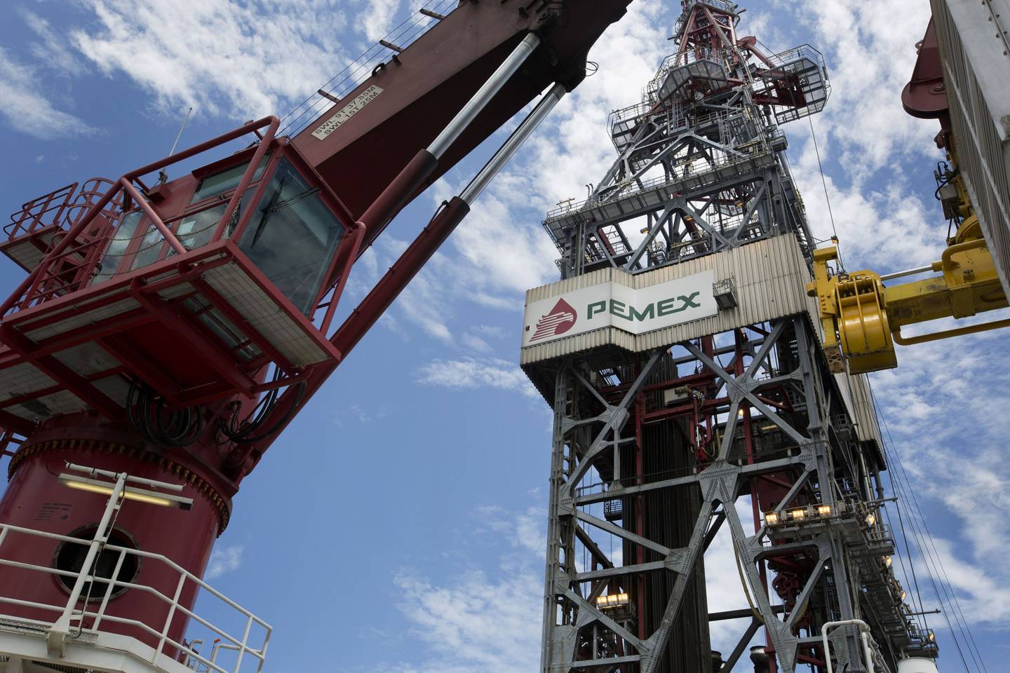 A crane stands next to Petroleos Mexicanos (Pemex) signage displayed on the company's La Muralla IV deep sea crude oil platform in the waters off Veracruz, Mexico, on Friday, Aug.30, 2013. Gulf of Mexico crudes strengthened on concern that the conflict in Syria might spread and threaten imports from the Middle East. Photographer: Susana Gonzalez/Bloomberg