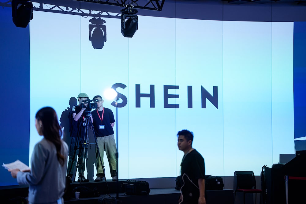 Signage for Shein Global Holdings Ltd. displayed ahead of the companys listing ceremony at the Hong Kong Stock Exchange in Hong Kong, China, on Tuesday, Sept. 1, 2026. Shein shares fell as much as 10% in their Hong Kong debut after an initial public offering that raised HK$13.6 billion ($1.7 billion). Photographer: Lam Yik/Bloomberg Signage for Shein Global Holdings Ltd. displayed ahead of the companys listing ceremony at the Hong Kong Stock Exchange in Hong Kong, China, on Tuesday, Sept. 1, 2026. Shein shares fell as much as 10% in their Hong Kong debut after an initial public offering that raised HK$13.6 billion ($1.7 billion). Photographer: Lam Yik/Bloomberg