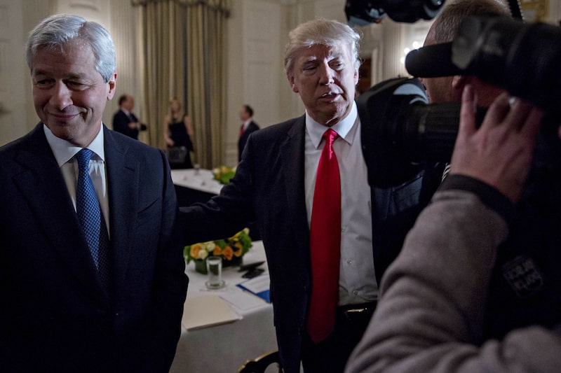 U.S. President Donald Trump stands next to Jamie Dimon, chief executive officer of JPMorgan Chase & Co., left, as he greets attendees during a Strategic and Policy Forum meeting in the State Dining Room of the White House in Washington, D.C., U.S., on Friday, Feb. 3, 2017 U.S. President Donald Trump stands next to Jamie Dimon, chief executive officer of JPMorgan Chase & Co., left, as he greets attendees during a Strategic and Policy Forum meeting in the State Dining Room of the White House in Washington, D.C., U.S., on Friday, Feb. 3, 2017