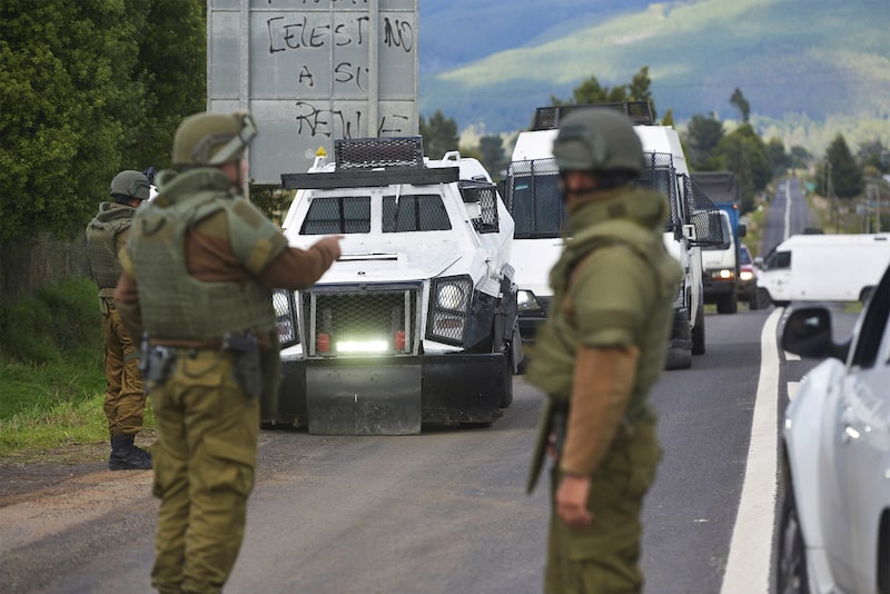 Members of the Chilean police guard the highway near the site where three policemen were murdered, at a Mapuche area in Cañete, Biobio region, Chile on April 27, 2024. Three police officers were murdered early this Saturday in a Mapuche area in southern Chile, victims of an ambush on the day the anniversary of the police institution is commemorated, President Gabriel Boric reported. (Photo by GUILLERMO SALGADO / AFP) (Photo by GUILLERMO SALGADO/AFP via Getty Images) Members of the Chilean police guard the highway near the site where three policemen were murdered, at a Mapuche area in Cañete, Biobio region, Chile on April 27, 2024. Three police officers were murdered early this Saturday in a Mapuche area in southern Chile, victims of an ambush on the day the anniversary of the police institution is commemorated, President Gabriel Boric reported. (Photo by GUILLERMO SALGADO / AFP) (Photo by GUILLERMO SALGADO/AFP via Getty Images)