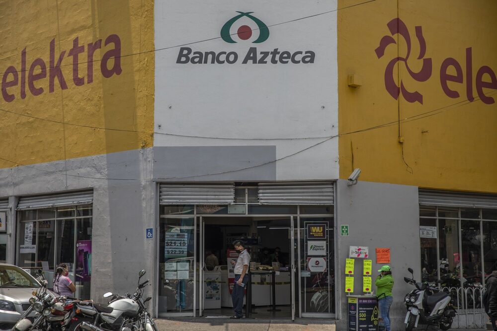 An employee wearing a protective mask stands at the entrance to a Banco Azteca SA bank branch inside a Grupo Elektra SAB store temporarily closed in Mexico City, Mexico, on Wednesday, May 27, 2020. Shares of Elektra, a Mexican financial company and appliance dealer, pared steep early losses Wednesday to end down 0.7% as Mexico's main stock index rose on hopes the U.S. is past the worst damage from the coronavirus pandemic. An employee wearing a protective mask stands at the entrance to a Banco Azteca SA bank branch inside a Grupo Elektra SAB store temporarily closed in Mexico City, Mexico, on Wednesday, May 27, 2020. Shares of Elektra, a Mexican financial company and appliance dealer, pared steep early losses Wednesday to end down 0.7% as Mexico's main stock index rose on hopes the U.S. is past the worst damage from the coronavirus pandemic.