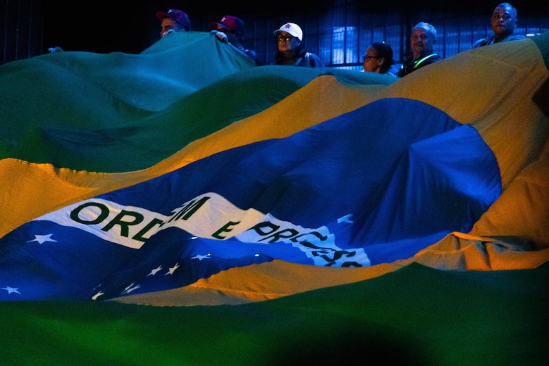 Supporters of Luiz Inacio Lula da Silva, Brazil's president, wave the national flag during the Workers' Party (PT) convention in Sao Paulo, Brazil, on Sunday, Aug. 2, 2026. President Lula maintained his lead over Flavio Bolsonaro ahead of October's election as a cloud of controversies swirled around the conservative challenger, a new poll found. Photographer: Maira Erlich/Bloomberg Supporters of Luiz Inacio Lula da Silva, Brazil's president, wave the national flag during the Workers' Party (PT) convention in Sao Paulo, Brazil, on Sunday, Aug. 2, 2026. President Lula maintained his lead over Flavio Bolsonaro ahead of October's election as a cloud of controversies swirled around the conservative challenger, a new poll found. Photographer: Maira Erlich/Bloomberg