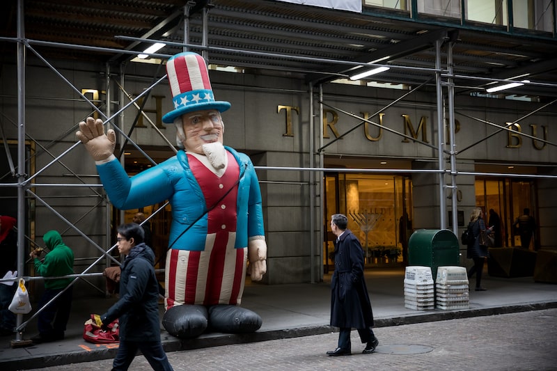 An Uncle Sam inflatable is displayed by the Bricklayers and Allied Craftworkers Union Local 1, protesting below standard wages, in front of the Trump building at 40 Wall Street in New York, U.S., on Friday, Dec. 14, 2018. Volatility continued to grip financial markets, with U.S. stocks erasing a weekly gain and Treasuries rising with the yen as mounting concern over the health of the global economy overshadowed positive trade developments and signs of strength in the American consumer. Photographer: Michael Nagle/Bloomberg An Uncle Sam inflatable is displayed by the Bricklayers and Allied Craftworkers Union Local 1, protesting below standard wages, in front of the Trump building at 40 Wall Street in New York, U.S., on Friday, Dec. 14, 2018. Volatility continued to grip financial markets, with U.S. stocks erasing a weekly gain and Treasuries rising with the yen as mounting concern over the health of the global economy overshadowed positive trade developments and signs of strength in the American consumer. Photographer: Michael Nagle/Bloomberg