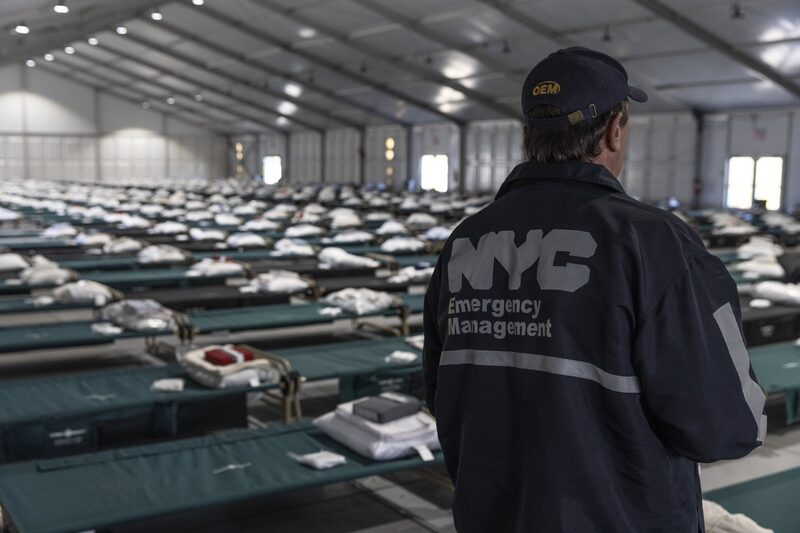 An NYC Emergency Management official during a tour of a new migrant holding center on Randall's Island in New York. An NYC Emergency Management official during a tour of a new migrant holding center on Randall's Island in New York.